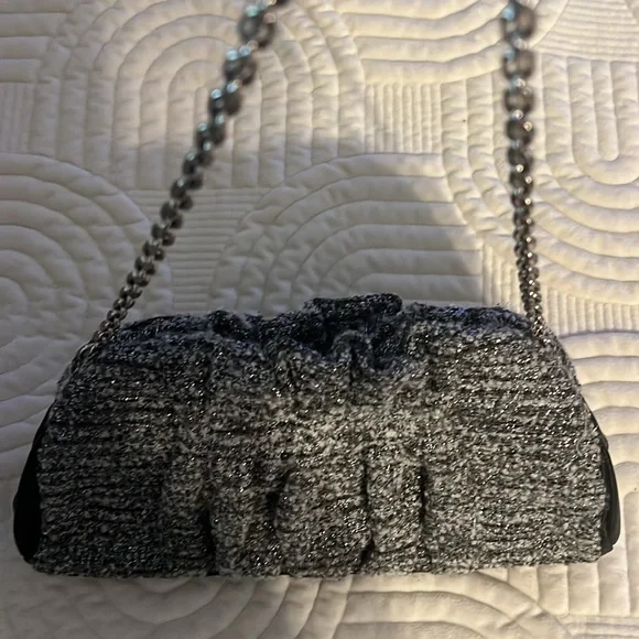 Shades of woven gray, and silver and black leather trim.Removable silver chain